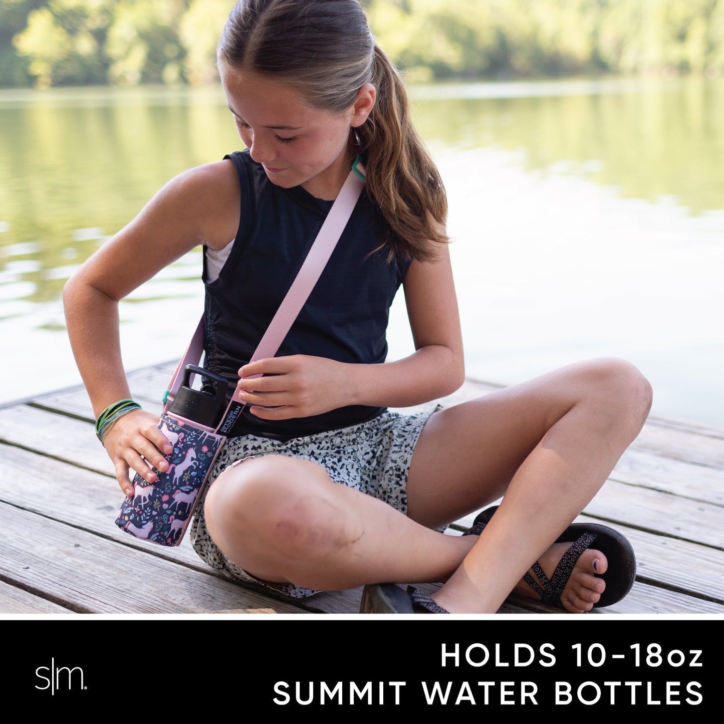 Child wearing navy blue sleeveless tank top carrying a pale pink sling bag with Adventure-Sling branding, demonstrating the product's features and fit for kids.