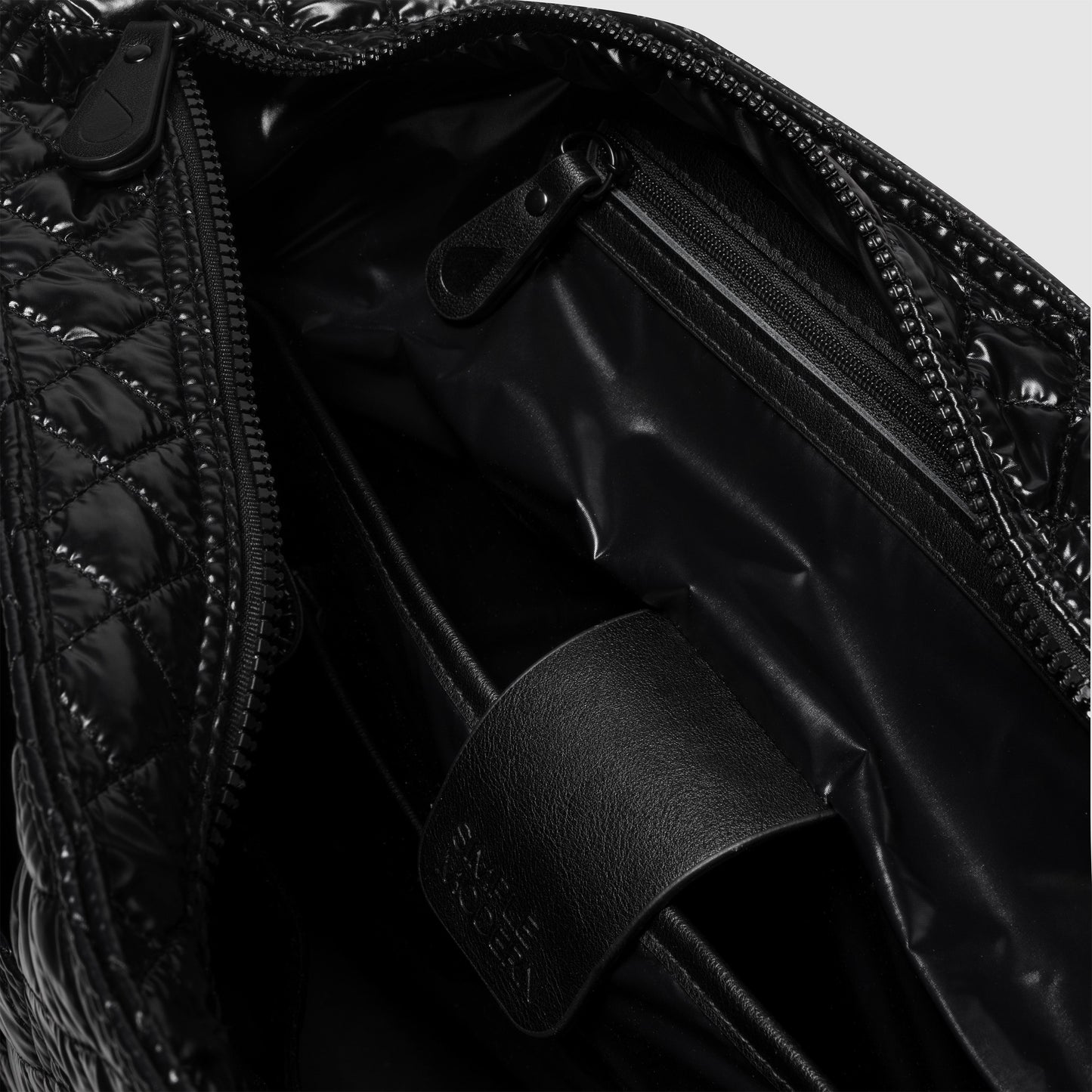 Glossy black interior surface with reflective highlights and deep shadows in monochromatic design