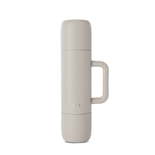 Light greige ceramic vessel with soft taupe coloring and warm neutral undertones covering the body.