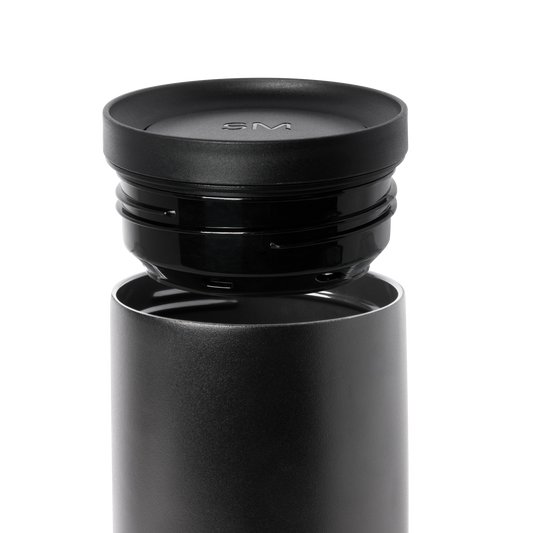 Dark gray cylindrical container with matte finish and removable black lid, shown against white background.