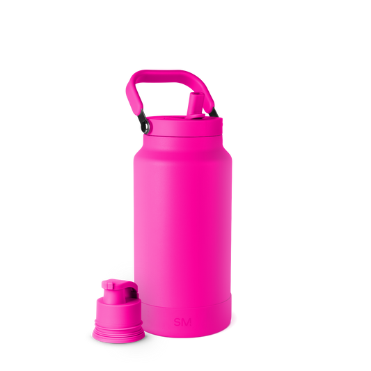 Bright hot pink spray bottle with white background