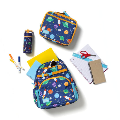 Fletcher Kids' Backpack in medium size with navy blue base and colorful space-themed print, displayed with matching lunch box, water bottle, notebooks, scissors, markers, and colored paper on white background.