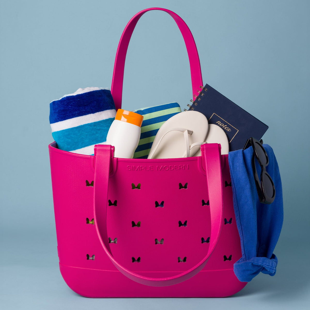 Vibrant hot pink design on soft blue-gray background with accents of royal blue, white, cream, navy, orange, and teal in a bright, playful color palette.