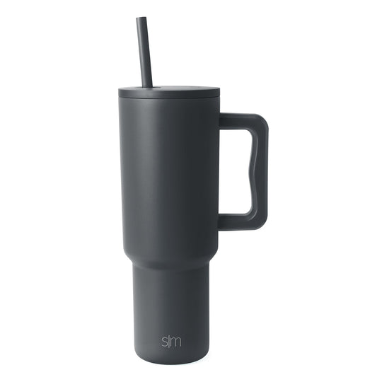 Charcoal gray Trek Tumbler with tapered cylindrical design, fitted lid, centered straw, and rectangular handle against white background