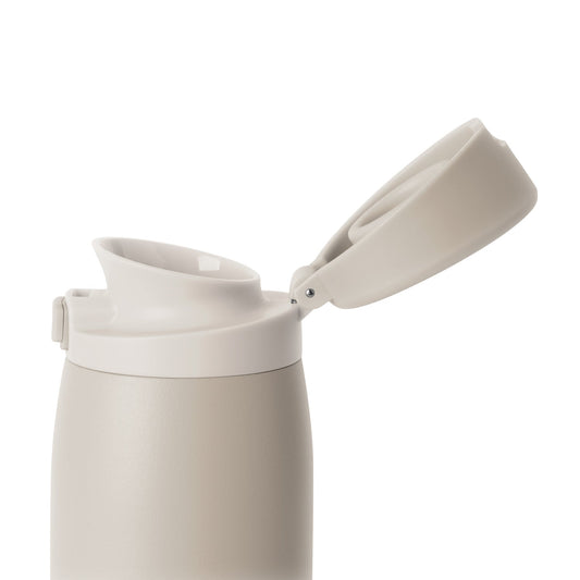 Beige matte finish tumbler with cream-colored flip-top lid and spout on neutral background