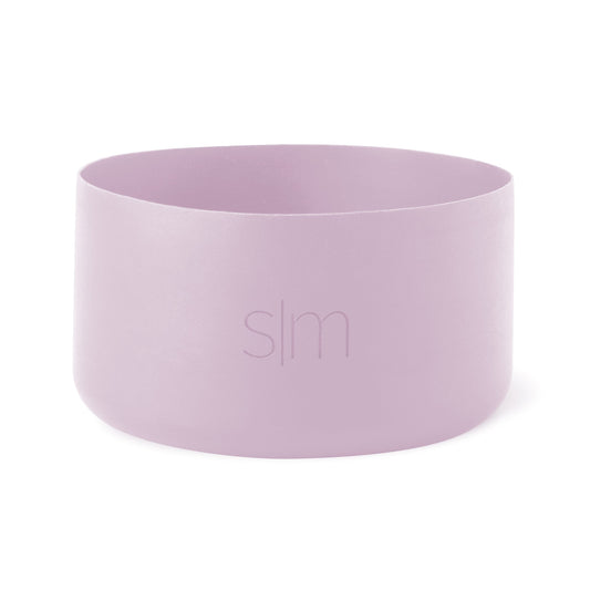 Soft lavender pink cylindrical drinking cup with curved sides and open top on white background
