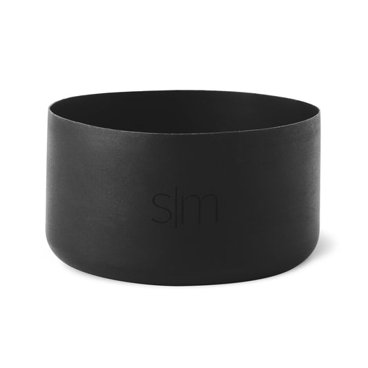 Matte black cylindrical boot product on white background with soft textured finish