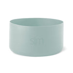 Soft sage green cylindrical boot vessel with muted celadon tone and subtle tonal variations throughout
