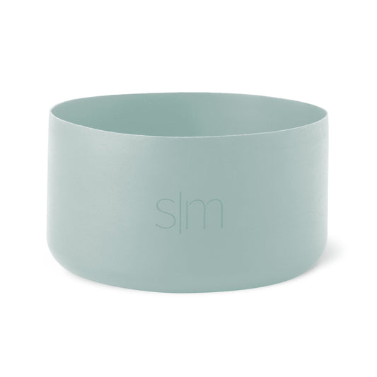 Soft sage green cylindrical boot vessel with muted celadon tone and subtle tonal variations throughout