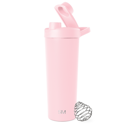 Pale pink cylindrical insulated tumbler with secure lid and carry handle against white background, featuring matte finish and minimalist design.