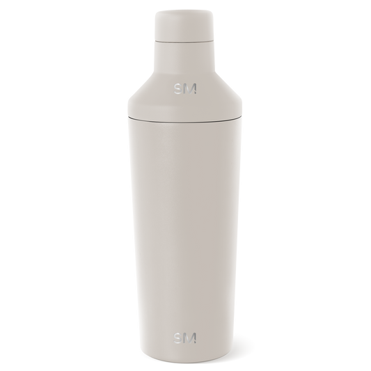 Cream-colored cosmetic bottle with minimalist design displayed against a white background