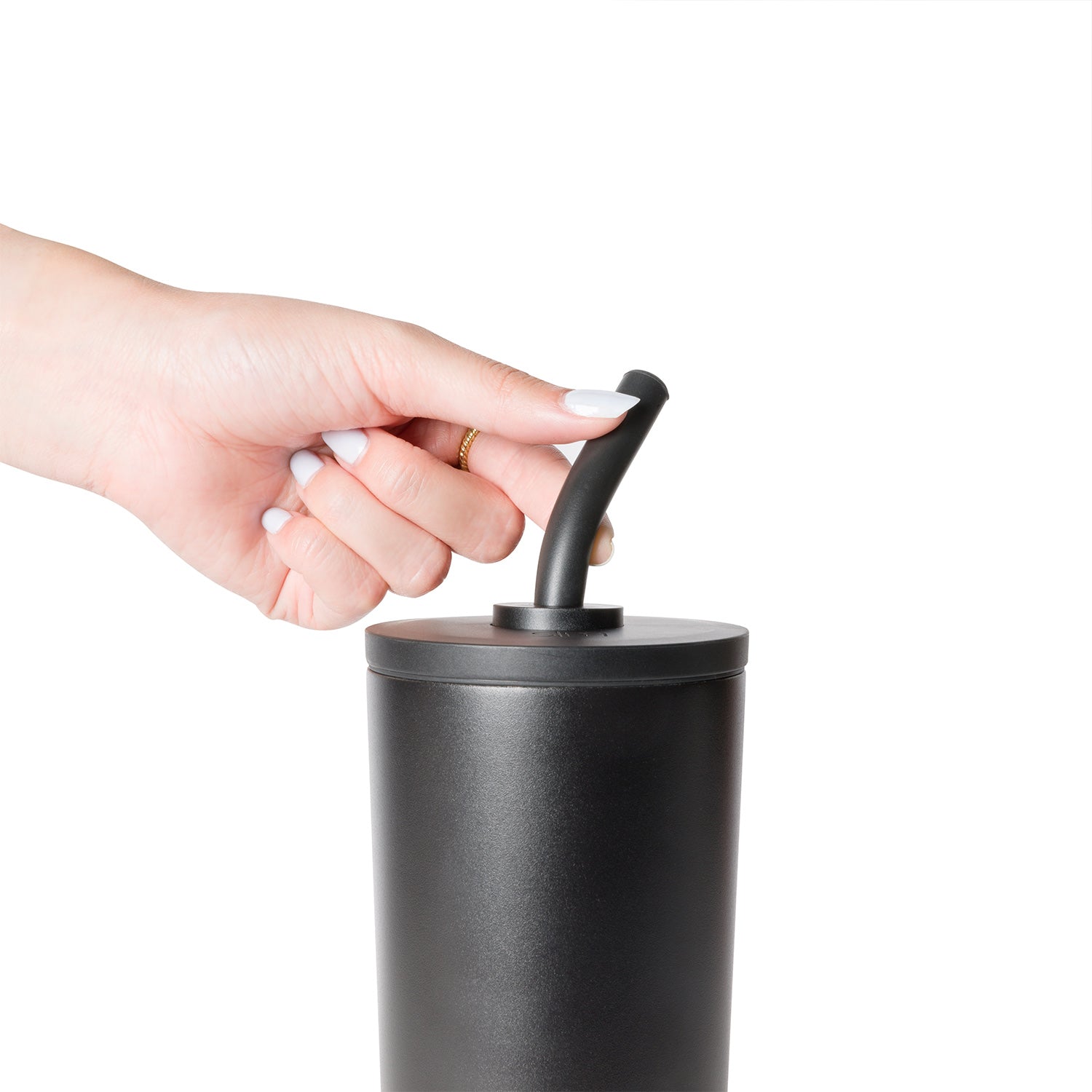 Hand holding a white straw next to a classic signature product on white background