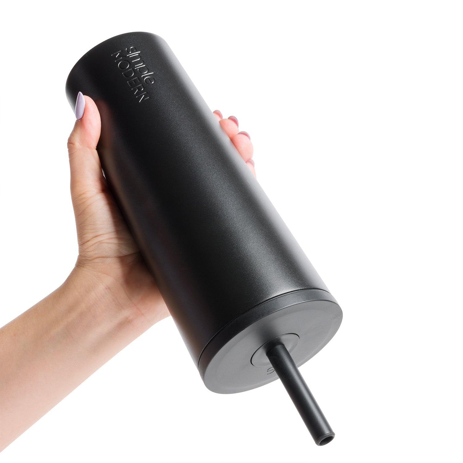 Black matte tumbler with gray base and accent ring held by a hand, white logo visible on cup