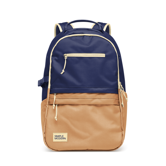 Two-tone backpack with deep navy blue upper portion, warm tan brown lower half, and cream trim accents.