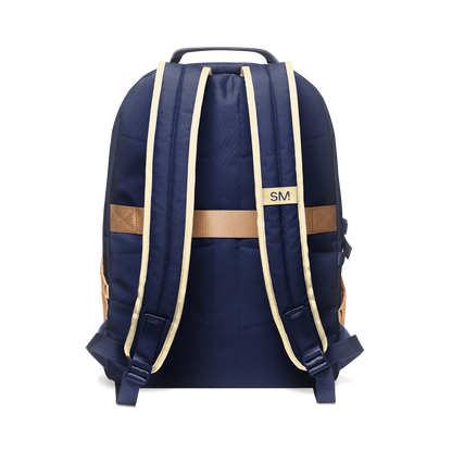 Deep navy blue backpack with tan and cream shoulder straps, handle, and decorative bands