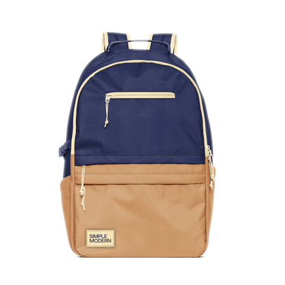Two-tone navy blue and tan backpack with cream trim and hardware
