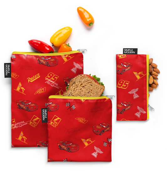 Red fabric with yellow zippers and yellow accents, featuring peppers and almonds pattern