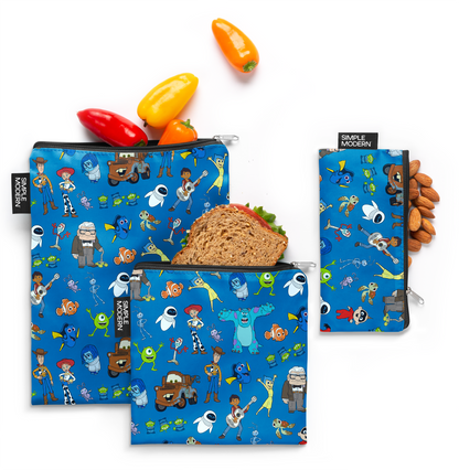Collection of colorful Pixar-themed lunch bags on royal blue background, featuring bright red, yellow, and accent colors in modern pixelated style design.
