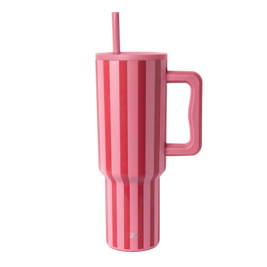 Modern tall tumbler with handle featuring vertical striped pattern in shades of pink, displayed against white background