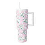 White insulated tumbler with handle and lid featuring pink flowers and green foliage pattern, Simple Modern logo, against white background.