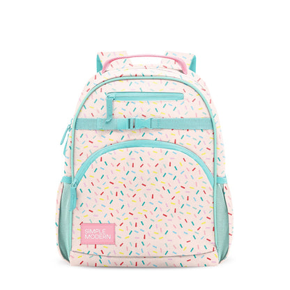 Pale pink children's backpack with turquoise trim, colorful confetti pattern, front pocket with "SIMPLE MODERN" label, padded shoulder straps, side mesh pockets, and compression strap. Studio product shot on white background.