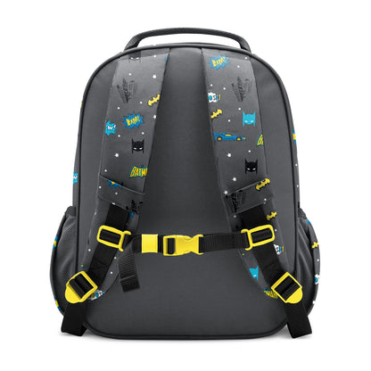 Charcoal gray children's backpack with yellow and blue Batman-themed graphics including "POW," "BAM," and "BATIM" text, black mesh pockets, padded yellow-buckled straps, and chest buckle, shown against white background.
