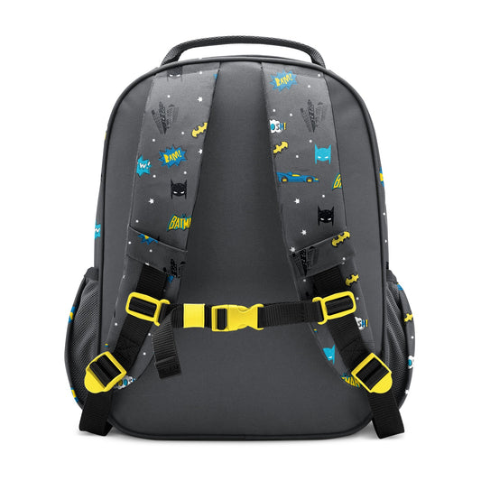 Charcoal gray children's backpack with yellow and blue Batman-themed graphics including "POW," "BAM," and "BATIM" text, black mesh pockets, padded yellow-buckled straps, and chest buckle, shown against white background.