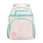 Pastel pink children's backpack with turquoise trim, colorful confetti dashes, three zippered compartments, side mesh pockets, turquoise handles, and Simple Modern label, photographed front-facing on white background.