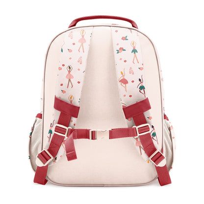 Blush pink children's backpack with crimson red handle and straps, viewed from back. Features padded support, mesh side pockets, and allover print of ballet dancers, pointe shoes, and florals in soft pastels.