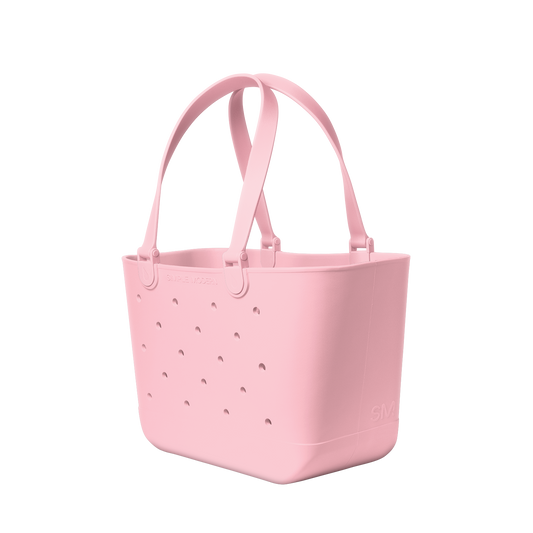 Soft pale pink tote bag displayed against a clean white background