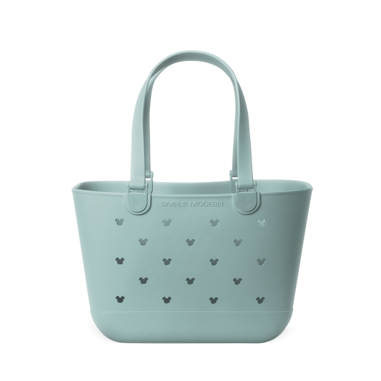 Soft sage green tote bag with dark gray-green cutout details and handles