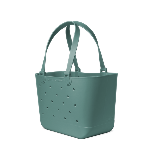 Soft sage green crossbody bag displayed against a neutral off-white background