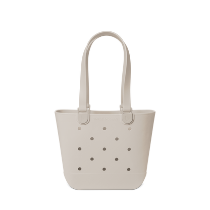 Soft beige canvas tote bag displayed against a light gray-white background