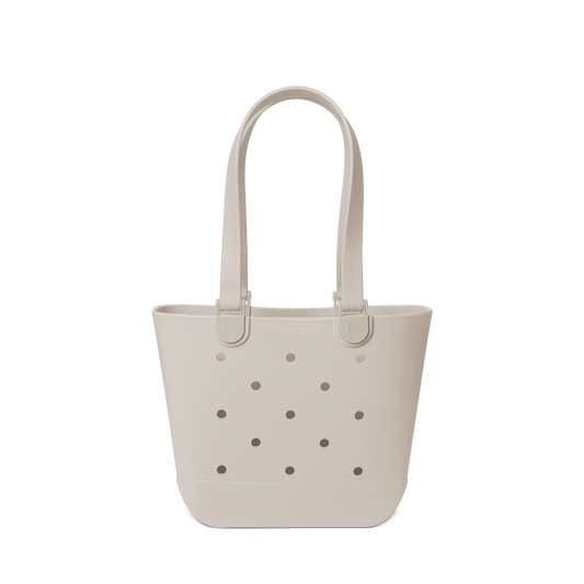Soft beige canvas tote bag displayed against a light gray-white background
