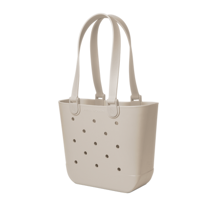 Cream-colored tote bag with handles and small circular perforations throughout the body, displayed on a neutral background.
