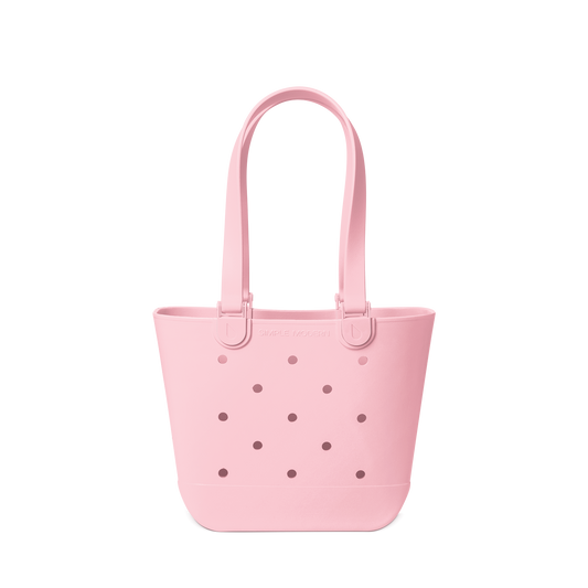 Soft pink tote bag against a white background