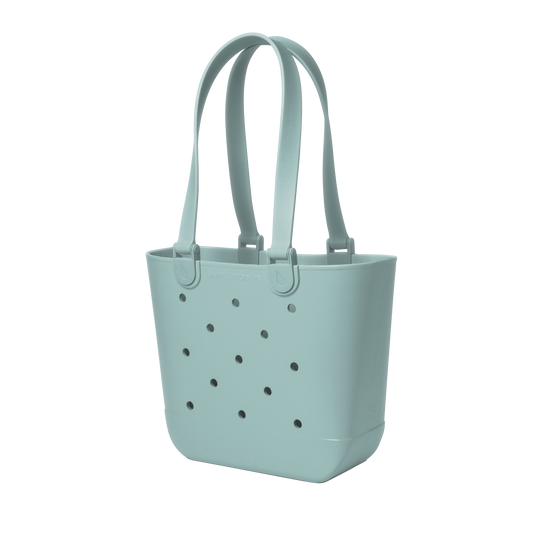 Soft sage green tote bag with small dark gray circular details, viewed from front
