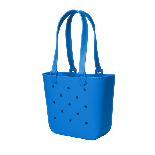 Blue tote bag with perforated details, viewed from the front. The bag features a solid royal blue color with small holes throughout the design.