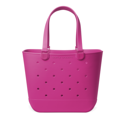 Hot pink magenta tote bag displayed against a white background. Spacious carryall with reinforced handles, suitable for shopping, travel, or everyday use.