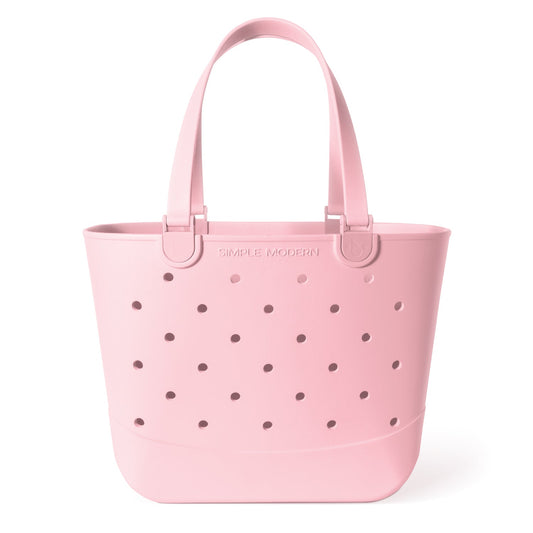 Soft pale pink tote bag with mauve circular perforations throughout the fabric, creating a textured pattern. Large capacity carryall with handles, shown against a neutral background.