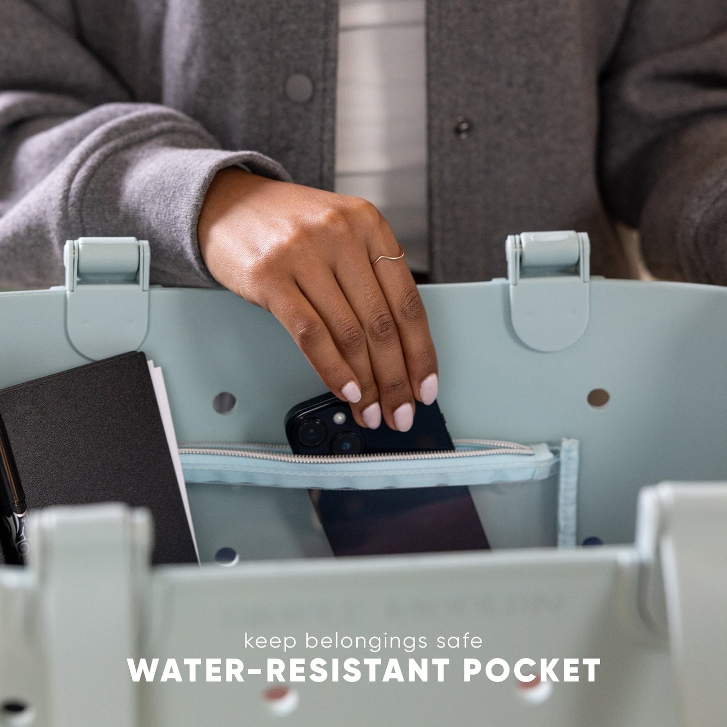 Sage green water-resistant getaway tote bag with open interior pocket displaying brown lining, showcasing durable fabric construction and functional design for travel.