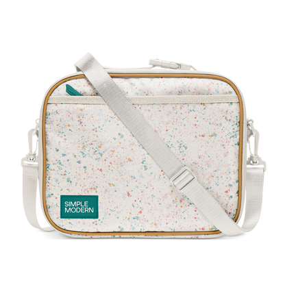 Cream colored canvas tote bag with multicolored speckled pattern in pink, coral, teal, turquoise, yellow-orange, and light blue throughout.