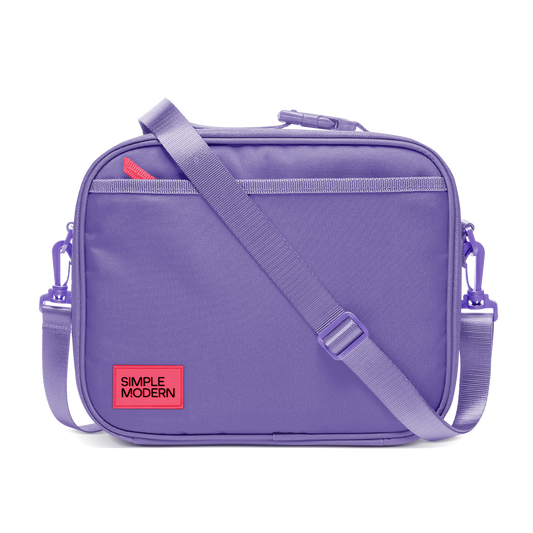 Purple backpack with light purple webbing straps and trim, featuring a bright neon red label detail