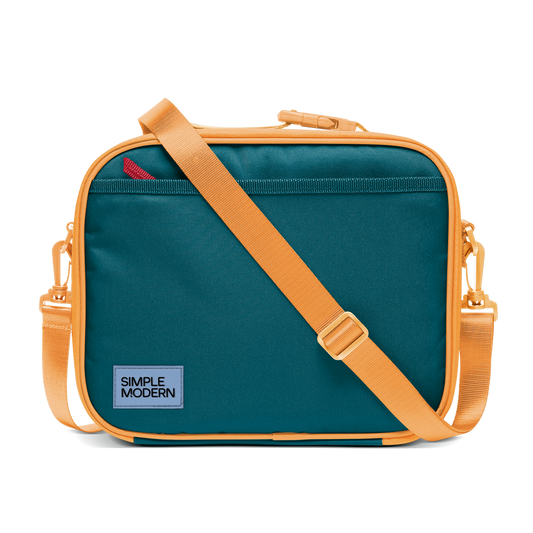 Deep teal canvas bag with apricot orange trim, piping, handles, and shoulder strap