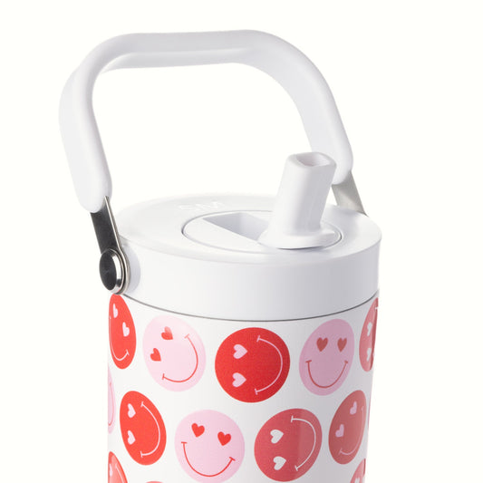 White background with red and pink smiley face motifs. Valentine's Day promotional design featuring bright red circles, soft pink circles, and white elements creating cheerful smiley face patterns.