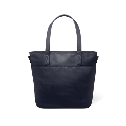 Deep navy blue leather tote bag with structured shape, shown from back view against white background, displaying sleek minimalist design and professional styling.