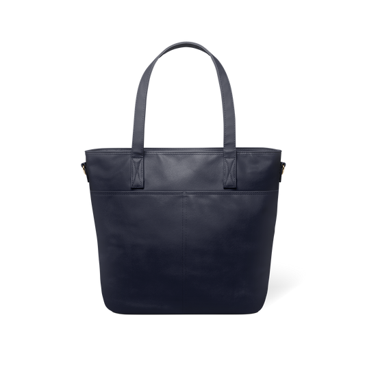 Deep navy blue leather tote bag with structured shape, shown from back view against white background, displaying sleek minimalist design and professional styling.