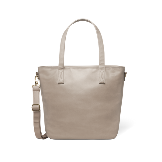 Beige tote bag with metal hardware accents displayed against a white background