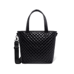 Black quilted handbag with light reflections on white background