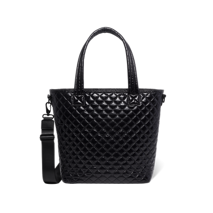 Black quilted handbag with light reflections on white background